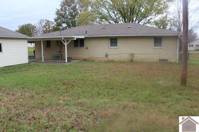 back of property featuring a lawn and a patio