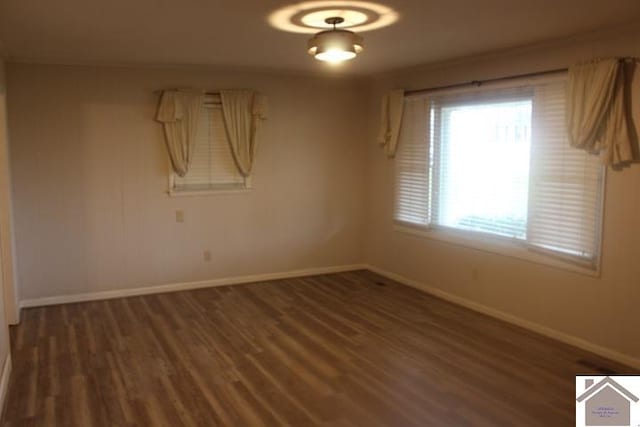 spare room featuring dark hardwood / wood-style floors