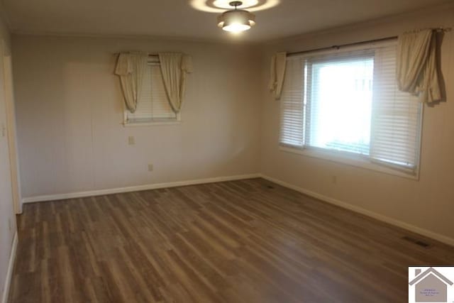 empty room featuring dark wood-type flooring