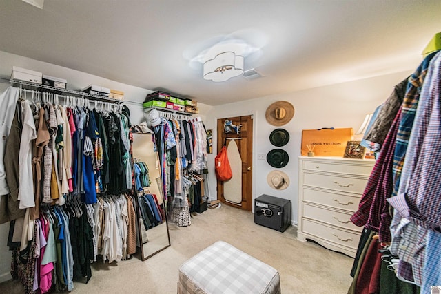 spacious closet featuring light colored carpet