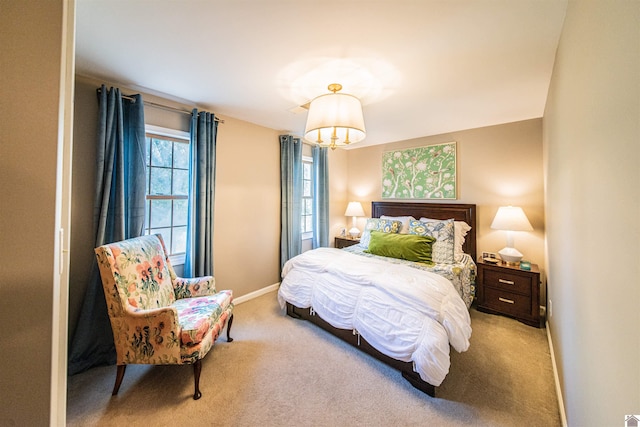 bedroom featuring carpet and a chandelier