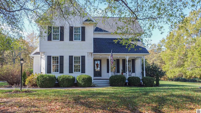 view of front of property featuring covered porch and a front lawn