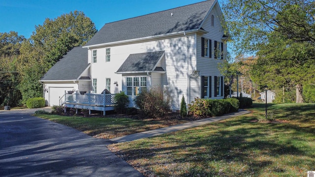 view of side of home featuring a yard and a wooden deck