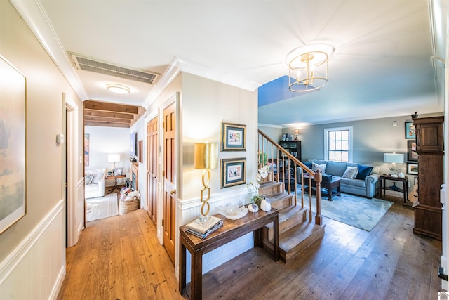 hallway with crown molding and hardwood / wood-style floors