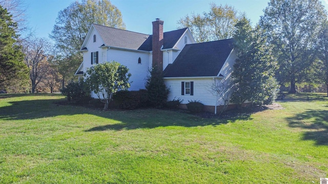 view of home's exterior with a yard