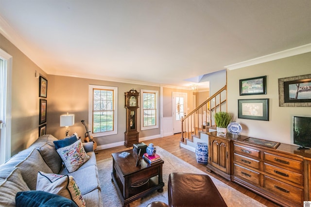 living room with ornamental molding and light wood-type flooring