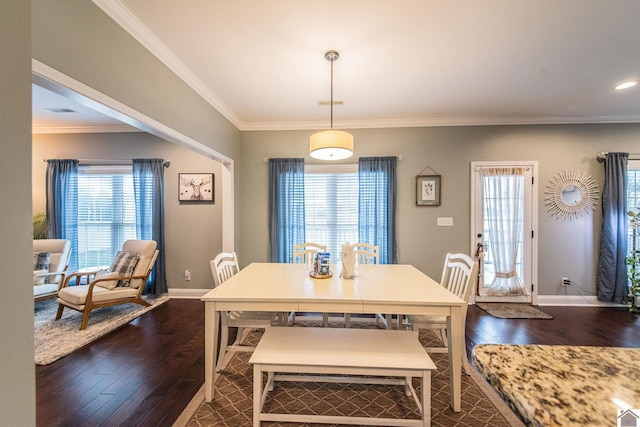 dining area with dark hardwood / wood-style flooring and crown molding