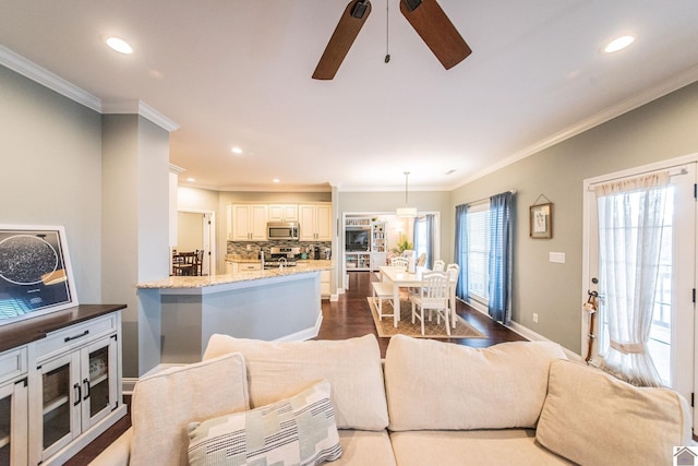 living room with light wood-type flooring, ceiling fan, and crown molding