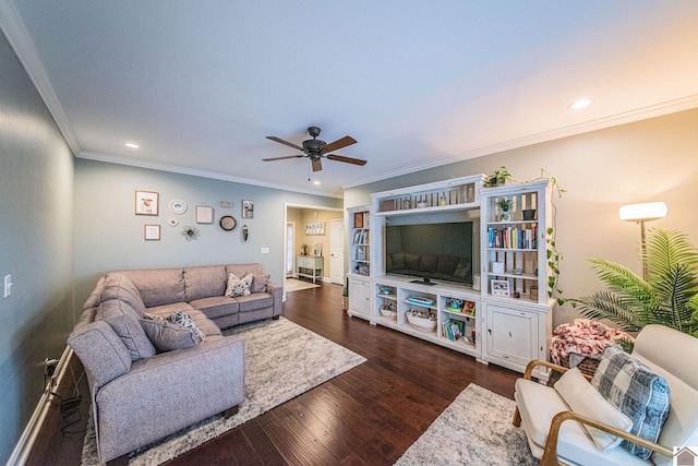 living room featuring dark hardwood / wood-style floors, ceiling fan, and ornamental molding