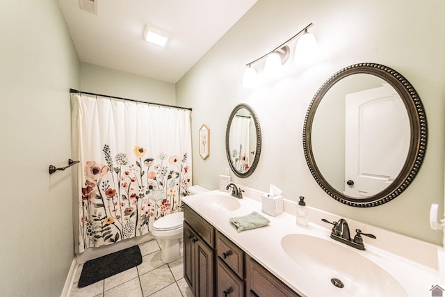 bathroom with tile patterned flooring, vanity, toilet, and walk in shower