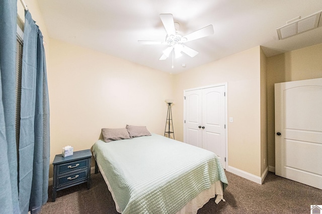 bedroom featuring dark colored carpet, a closet, and ceiling fan