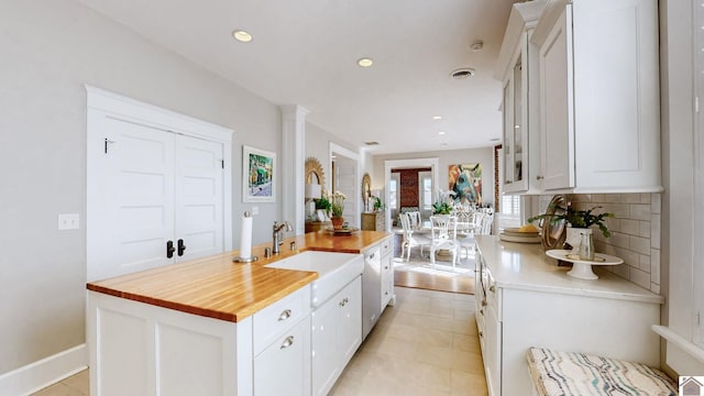 333 N 7th St Unit B, Paducah, KY 42001 - kitchen featuring wood counters, light tile patterned floors, decorative backsplash, white cabinets, and a sink
