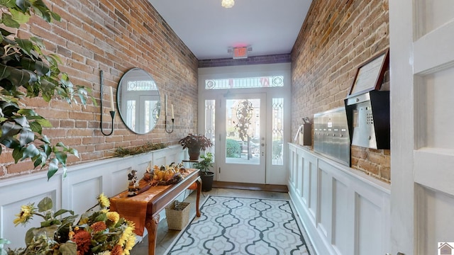 333 N 7th St Unit B, Paducah, KY 42001 - doorway to outside with a wainscoted wall, brick wall, and a decorative wall