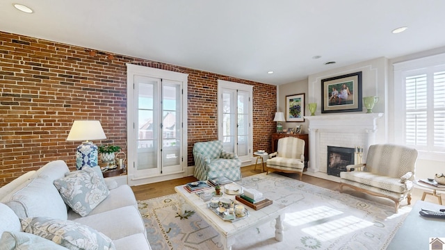 333 N 7th St Unit B, Paducah, KY 42001 - living area with a fireplace, wood finished floors, brick wall, and recessed lighting