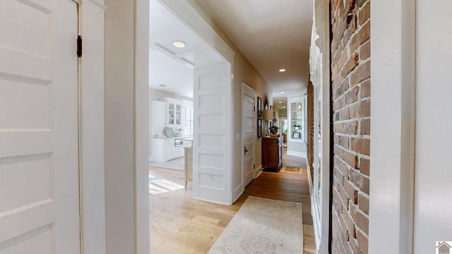 333 N 7th St Unit B, Paducah, KY 42001 - hallway with light wood finished floors, recessed lighting, and brick wall