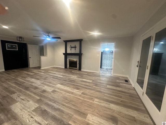 unfurnished living room featuring wood-type flooring and ceiling fan