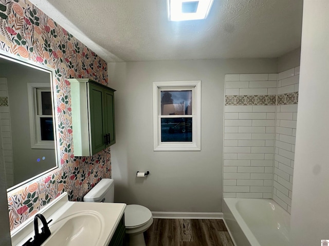 bathroom featuring hardwood / wood-style floors, vanity, a textured ceiling, and toilet