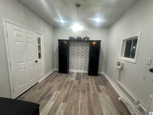 foyer entrance with hardwood / wood-style flooring and a notable chandelier