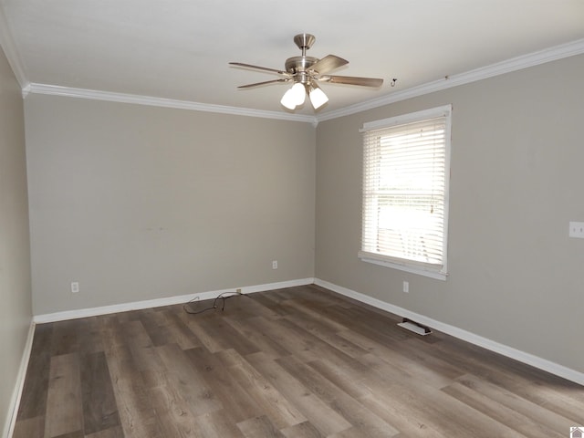 empty room featuring dark hardwood / wood-style floors, ceiling fan, and crown molding