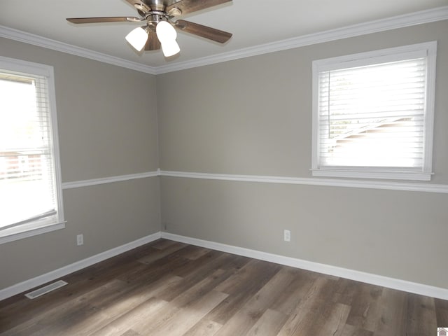 spare room featuring ornamental molding, ceiling fan, and dark wood-type flooring