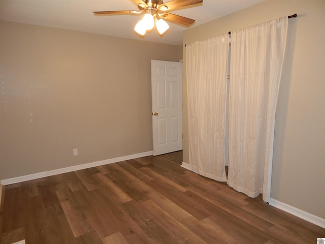 unfurnished bedroom with ceiling fan and dark wood-type flooring