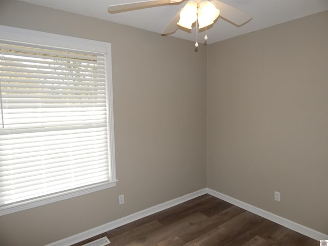 unfurnished room with dark hardwood / wood-style floors and ceiling fan