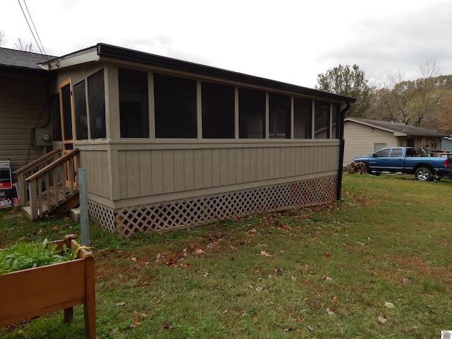 view of side of home with a lawn