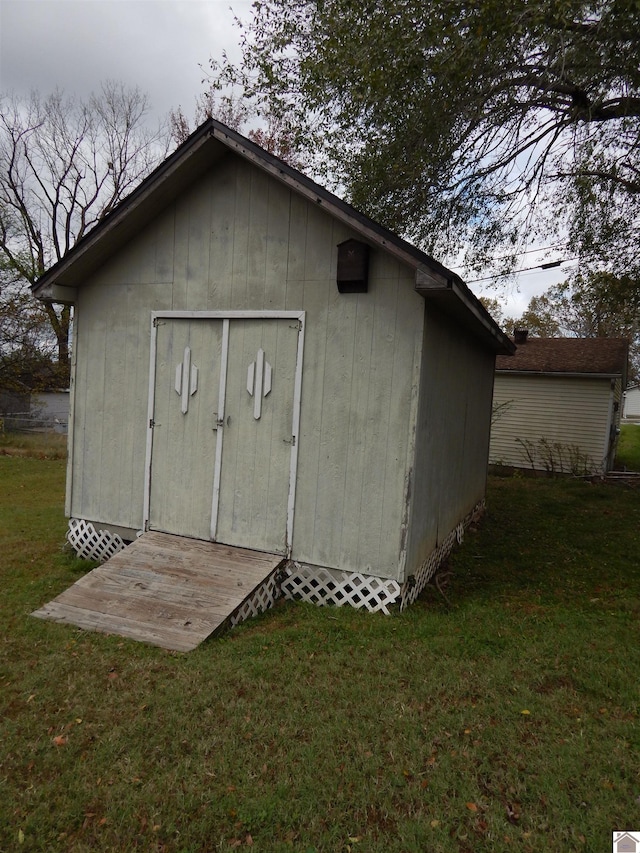 view of outbuilding with a lawn