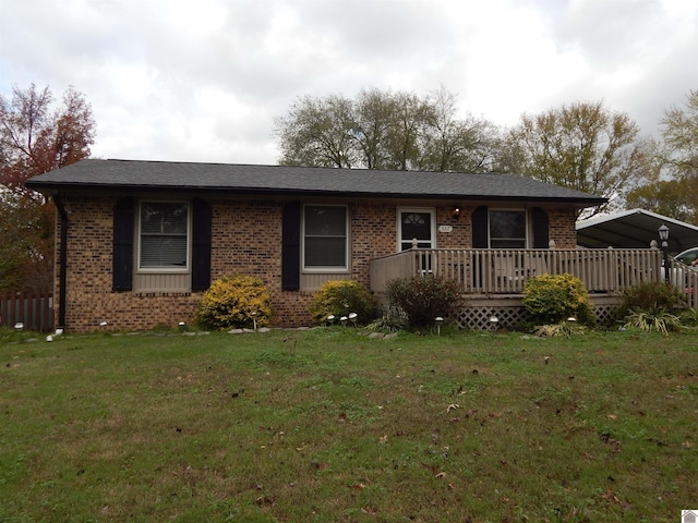 ranch-style house featuring a front yard and a wooden deck