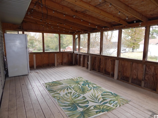 unfurnished sunroom with plenty of natural light and vaulted ceiling