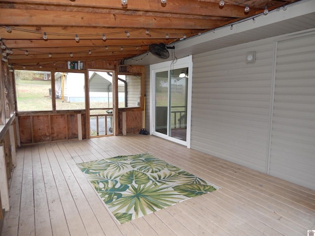 unfurnished sunroom with vaulted ceiling