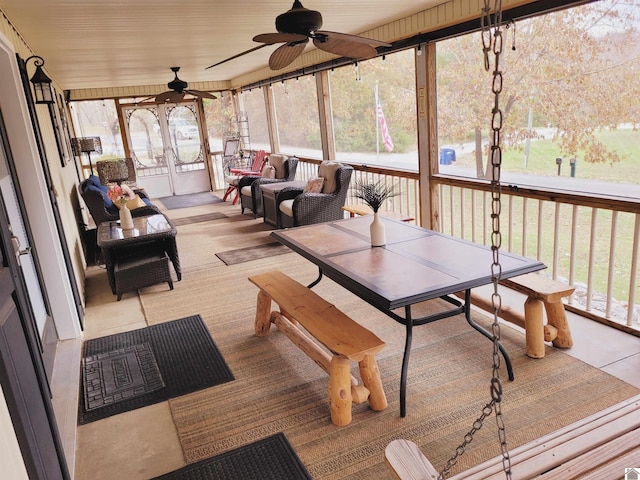 sunroom / solarium featuring ceiling fan