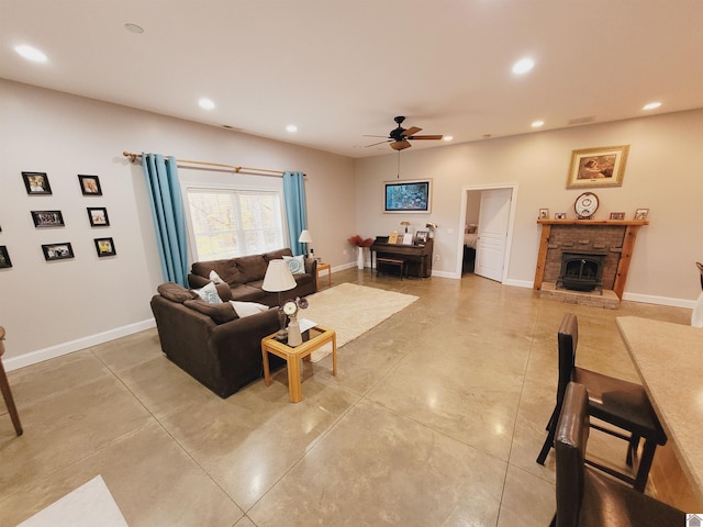 living room with ceiling fan and a fireplace