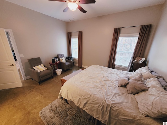 bedroom with multiple windows and ceiling fan