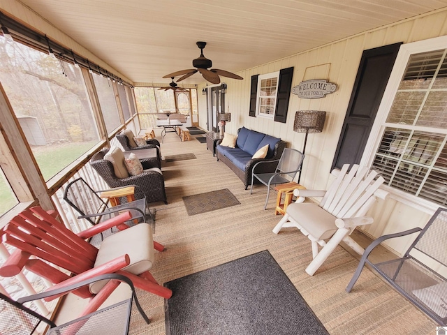 sunroom with ceiling fan and wood ceiling