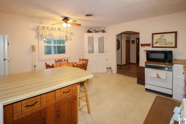 kitchen with ceiling fan and white refrigerator