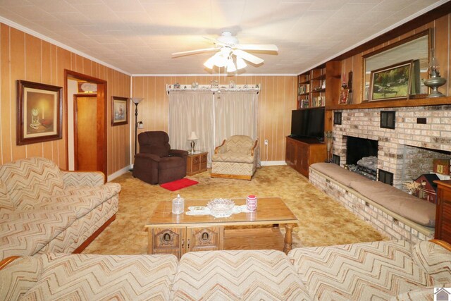 carpeted living room featuring ceiling fan, ornamental molding, wood walls, and a brick fireplace