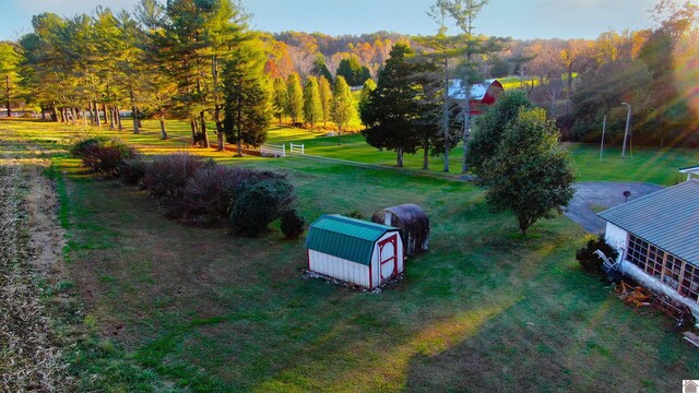 view of property's community with a lawn and a shed