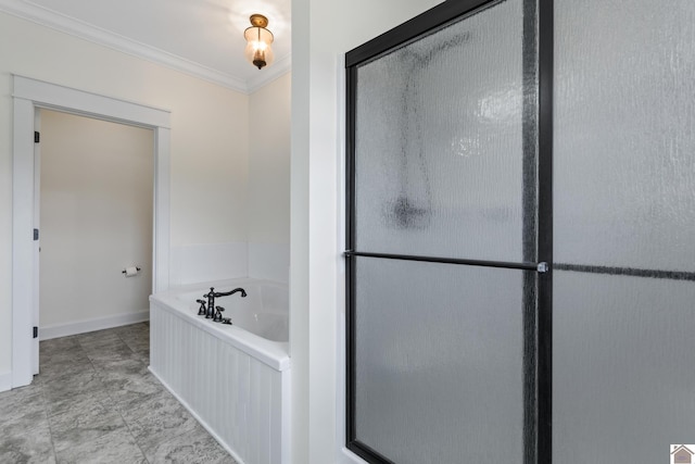 bathroom with ornamental molding and a bathing tub