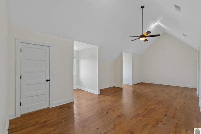 additional living space featuring ceiling fan, lofted ceiling, and hardwood / wood-style flooring