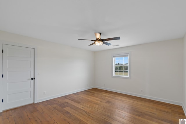 unfurnished room with hardwood / wood-style flooring and ceiling fan