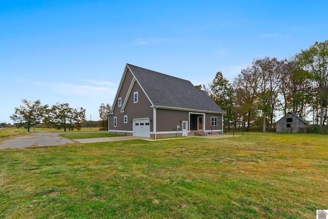 back of property with a lawn and a garage