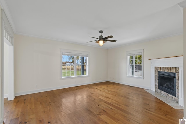 unfurnished living room featuring hardwood / wood-style floors, ceiling fan, and crown molding