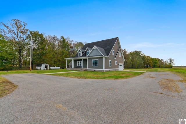 view of front of house featuring a front yard and a storage unit