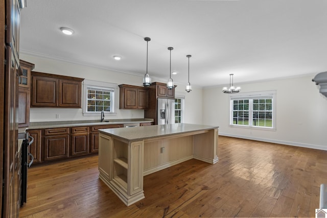 kitchen with dark hardwood / wood-style flooring, a center island, plenty of natural light, and appliances with stainless steel finishes