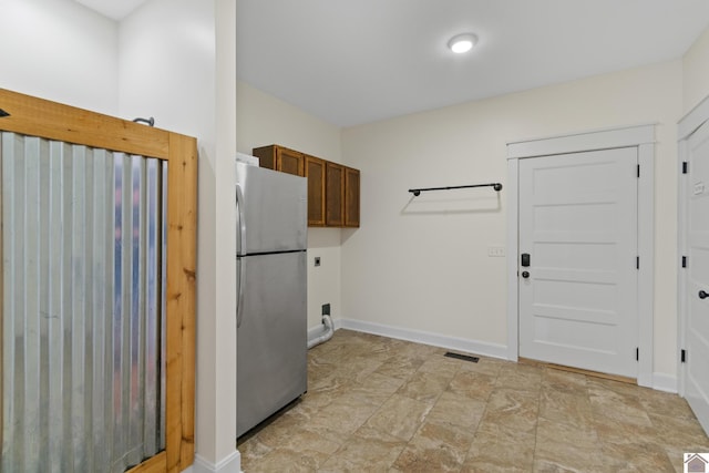 laundry room featuring cabinets and electric dryer hookup