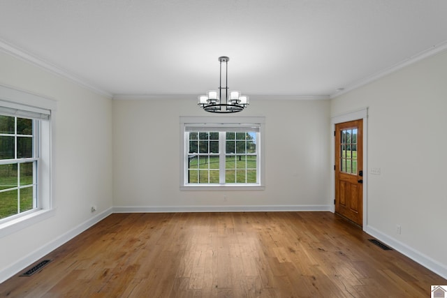 unfurnished dining area with light hardwood / wood-style flooring, a healthy amount of sunlight, and an inviting chandelier