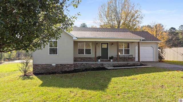 ranch-style home featuring a garage, covered porch, and a front lawn