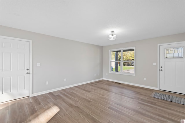 entryway with light hardwood / wood-style floors