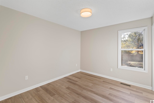 empty room with light hardwood / wood-style floors